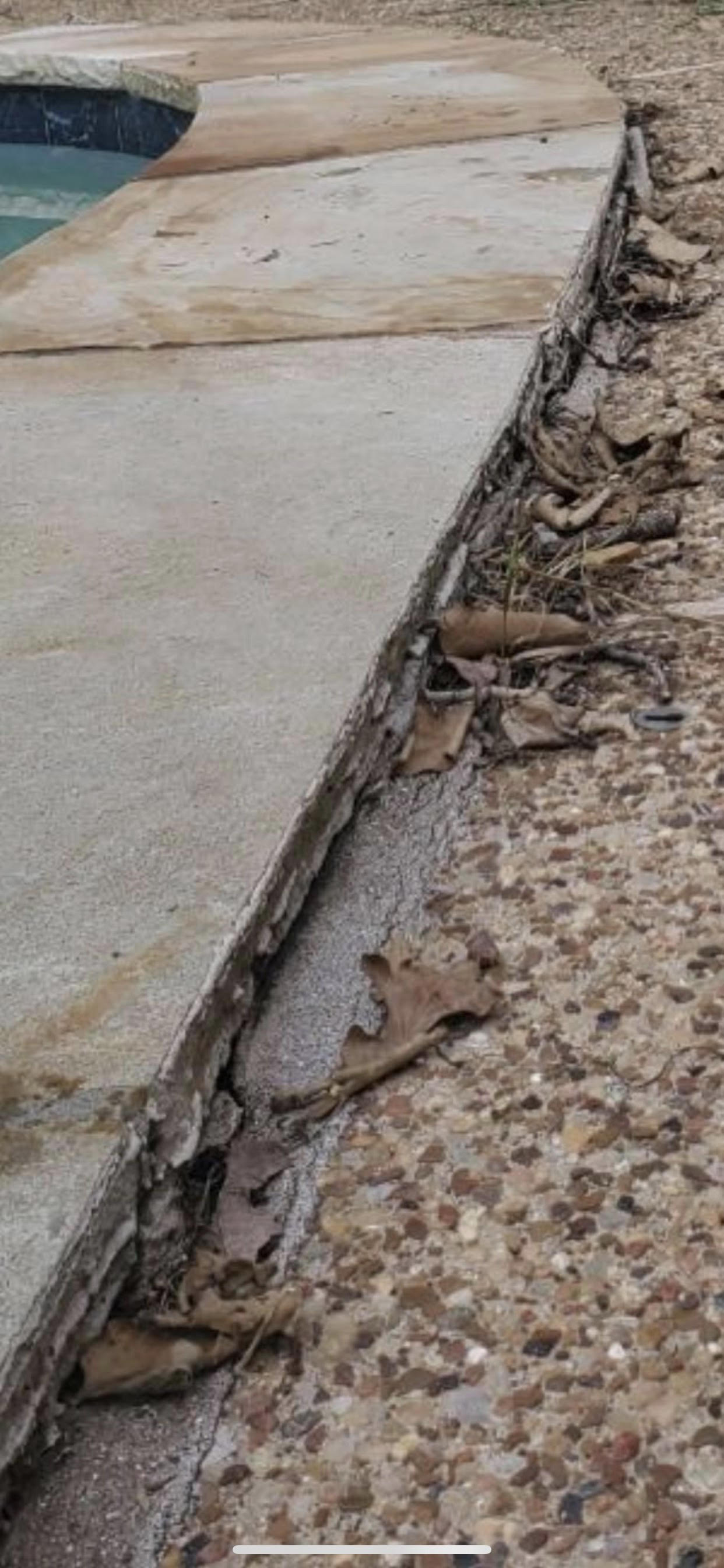 This Pool Deck has sunk, creating a tripping hazard.
